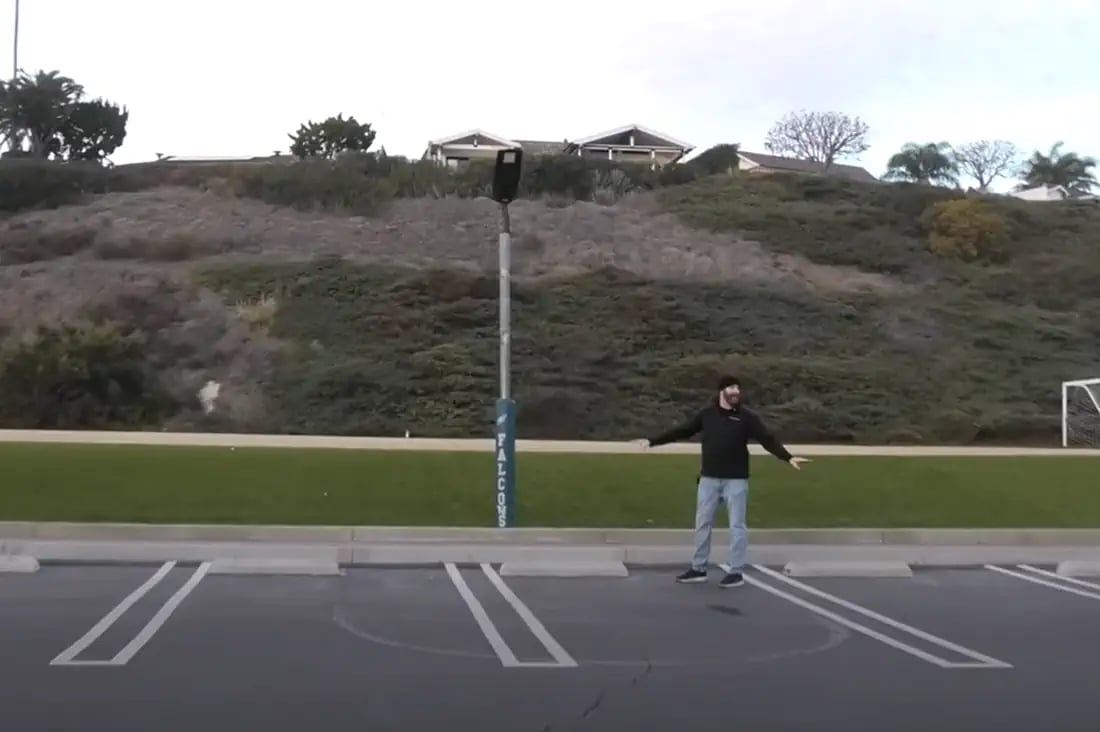 solar parking lot lights installed at night with pole-mounted panels
