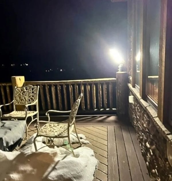 LED outdoor light installation operating during snowy winter conditions