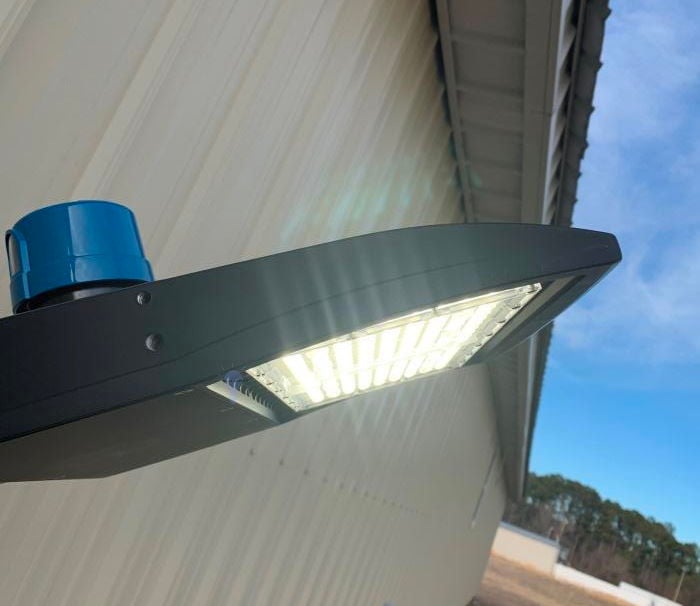150 watt LED parking lot shoebox light mounted on pole, Type III distribution with dark-sky compliant optics