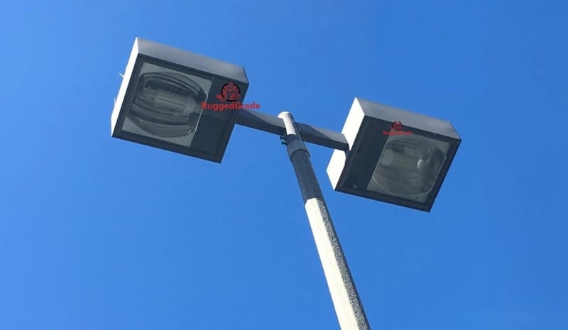 Street light fixture with LED corn light bulbs against a clear blue sky